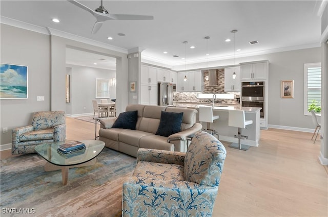 16733 Gilroy St, Bonita Springs, FL 34135 - living room with crown molding, recessed lighting, baseboards, ceiling fan, and light wood-style flooring