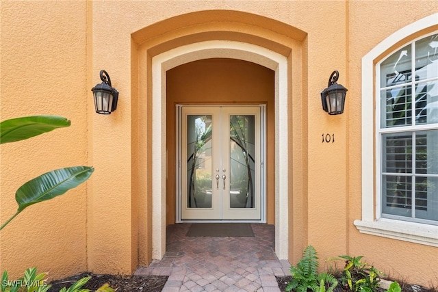 18580 Sandalwood Pointe Unit 101, Fort Myers, FL 33908 - doorway to property with french doors and stucco siding
