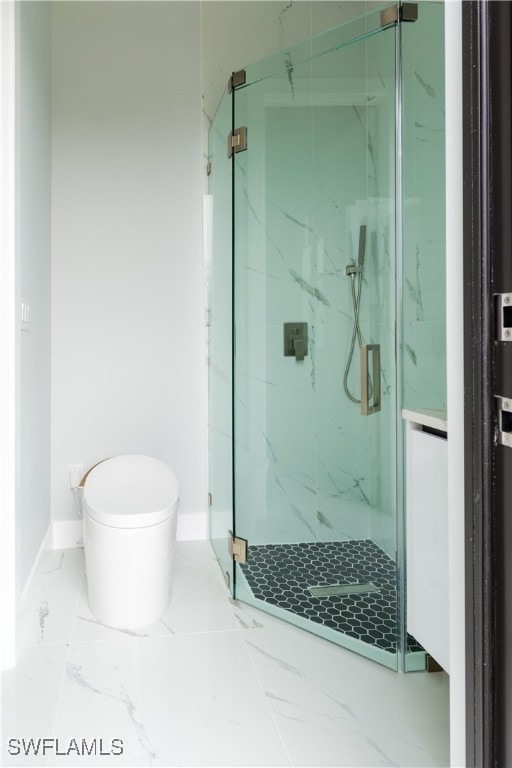 bathroom featuring toilet, baseboards, a marble finish shower, and marble finish floor