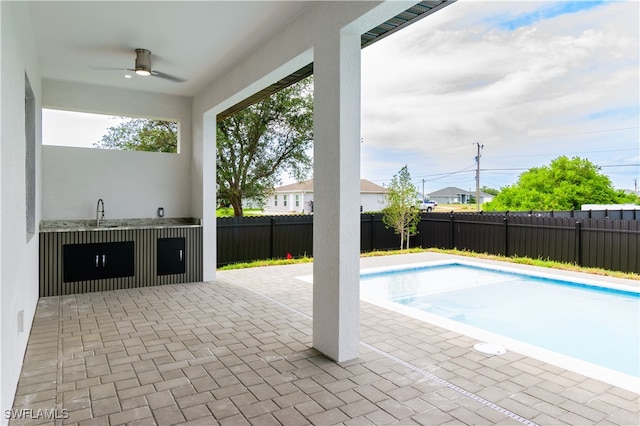 view of swimming pool featuring a patio, a fenced backyard, ceiling fan, and a fenced in pool