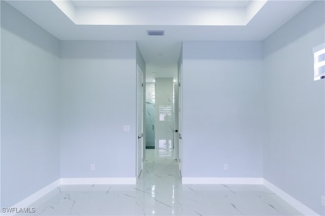 empty room featuring baseboards, marble finish floor, and visible vents