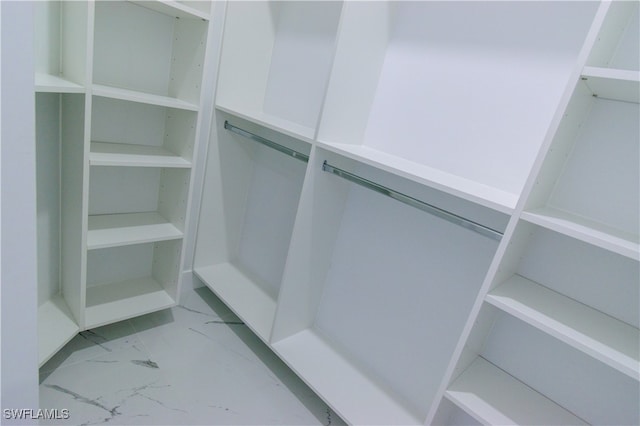 spacious closet featuring marble finish floor