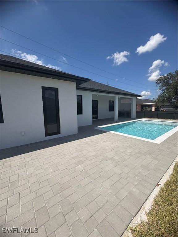 view of pool featuring a patio, fence, and a fenced in pool