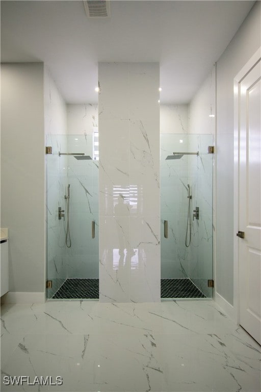 bathroom with visible vents, marble finish floor, a marble finish shower, and baseboards