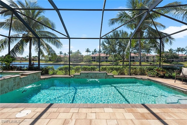 view of pool featuring a water view, glass enclosure, a patio area, and a pool with connected hot tub