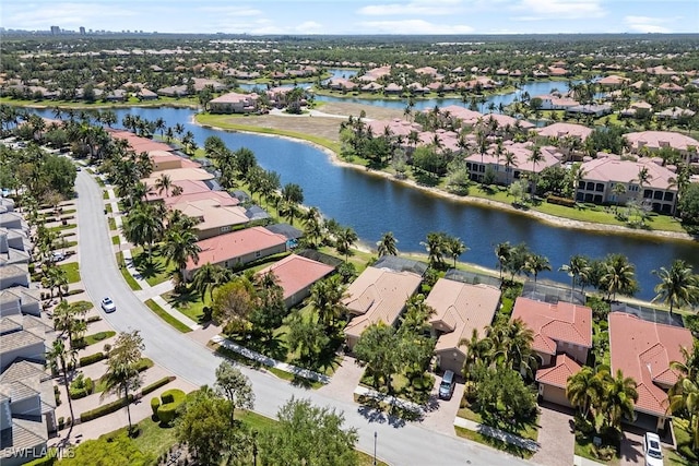 birds eye view of property with a water view and a residential view