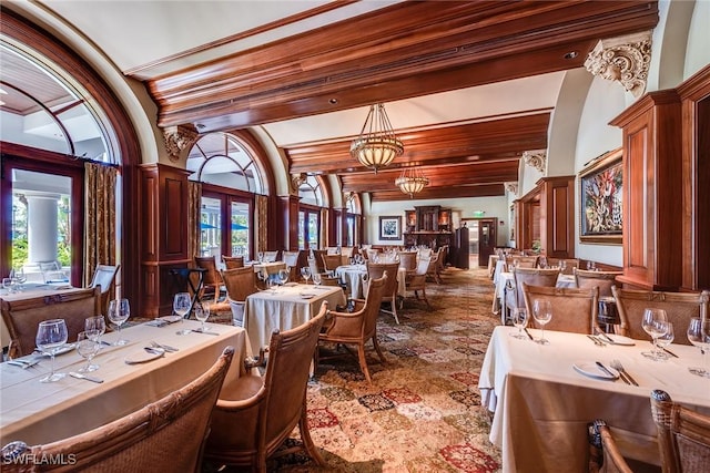 dining space with carpet floors and ornate columns