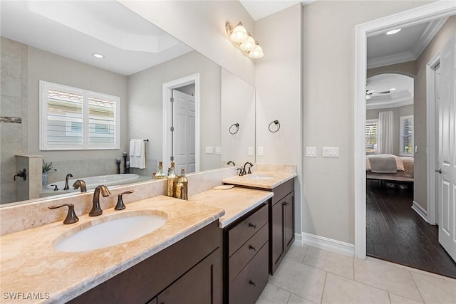 full bath with crown molding, ensuite bathroom, tile patterned flooring, and a healthy amount of sunlight