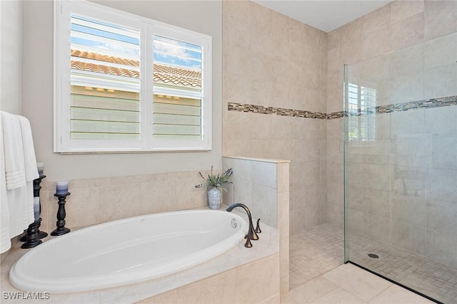 bathroom with a walk in shower and a bath