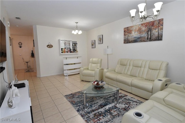 living area with baseboards, visible vents, a notable chandelier, and light tile patterned flooring