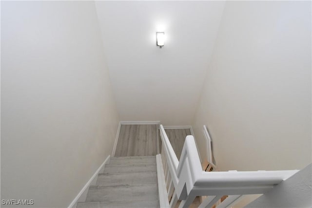 stairs featuring wood finished floors