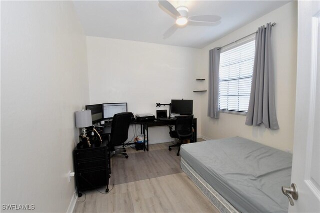 bedroom featuring wood finished floors, baseboards, and ceiling fan