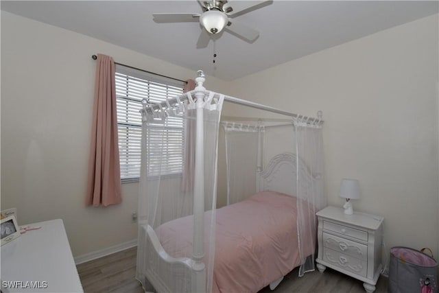 bedroom with wood finished floors, baseboards, and ceiling fan