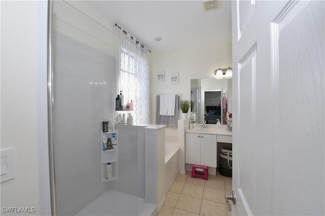 bathroom featuring a bath, visible vents, tile patterned flooring, and vanity