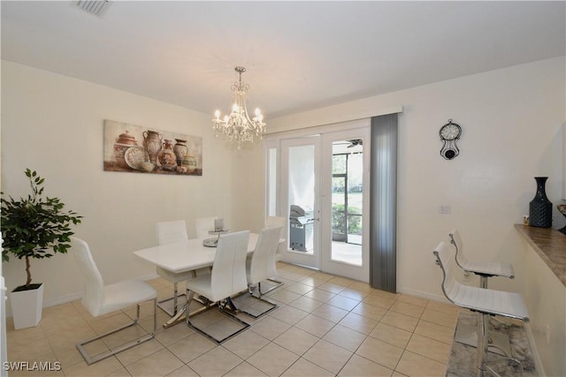 dining area featuring baseboards, a notable chandelier, visible vents, and light tile patterned floors