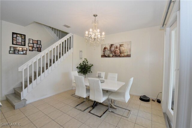 dining room with visible vents, stairs, a notable chandelier, and light tile patterned floors
