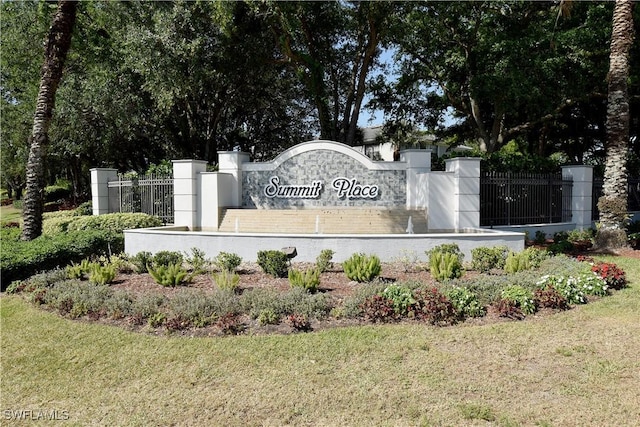community sign with a yard and fence
