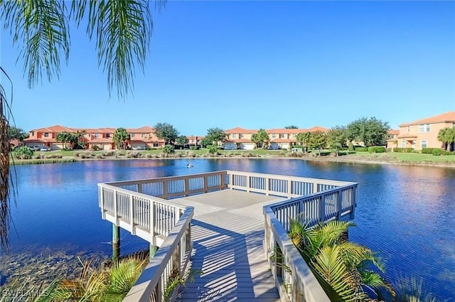 view of dock featuring a residential view and a water view