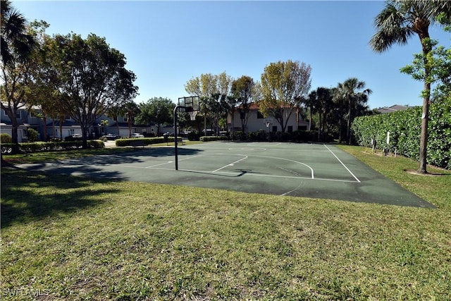 view of basketball court featuring a yard, community basketball court, and a residential view