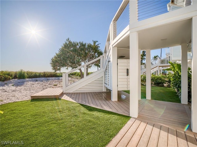 1072 S Seas Plantation Rd, Captiva, FL 33924 - wooden deck featuring stairway and a lawn