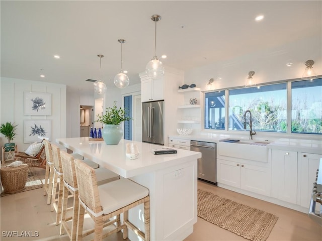 1072 S Seas Plantation Rd, Captiva, FL 33924 - kitchen featuring appliances with stainless steel finishes, a center island, white cabinets, recessed lighting, and light countertops