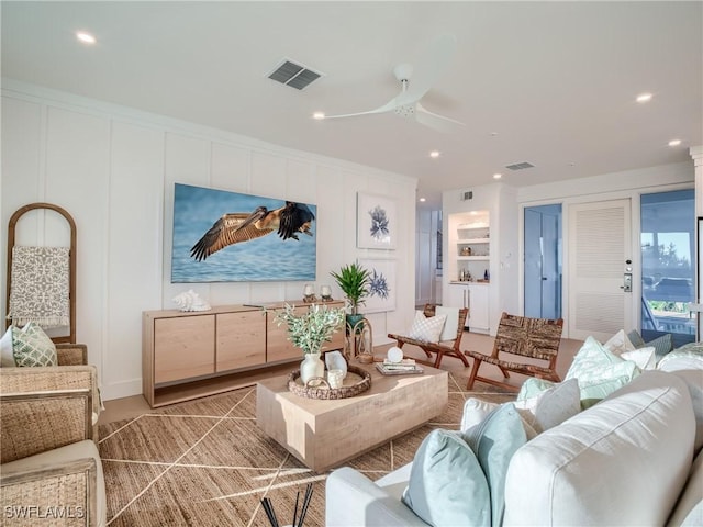1072 S Seas Plantation Rd, Captiva, FL 33924 - living room with a decorative wall, built in shelves, ceiling fan, and recessed lighting