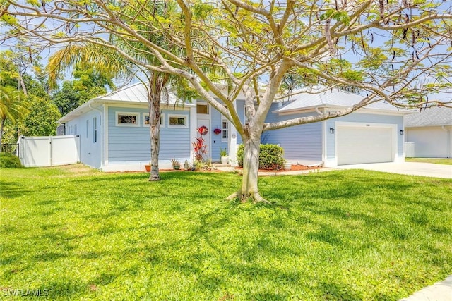 obstructed view of property with driveway, a front yard, and fence