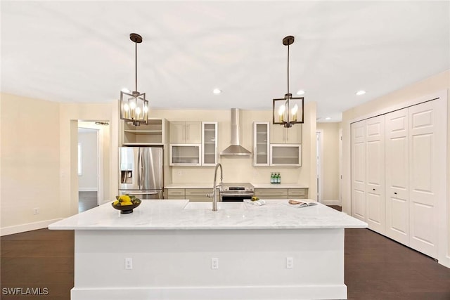 kitchen featuring wall chimney exhaust hood, appliances with stainless steel finishes, baseboards, and an inviting chandelier