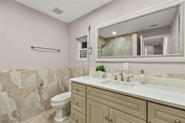 603 SW 53rd Ter, Cape Coral, FL 33914 - bathroom featuring vanity, toilet, tile walls, and visible vents