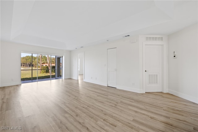505 Mardel Dr Unit 106, Naples, FL 34104 - unfurnished room featuring a tray ceiling, light wood-style floors, and baseboards