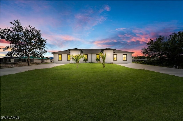 4646 Leonard Blvd S, Lehigh Acres, FL 33973 - view of front of property featuring driveway, stucco siding, and a front yard