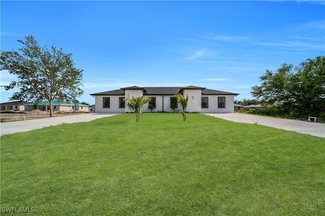 4646 Leonard Blvd S, Lehigh Acres, FL 33973 - view of front of property with stucco siding, a front lawn, and concrete driveway