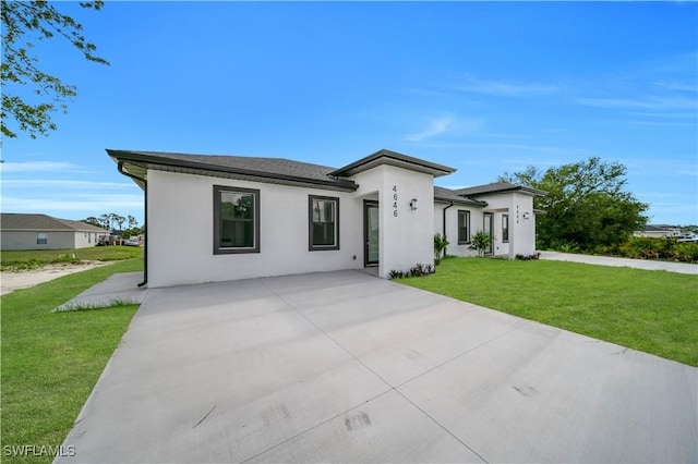 4646 Leonard Blvd S, Lehigh Acres, FL 33973 - view of front of house featuring stucco siding and a front lawn