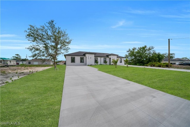 4646 Leonard Blvd S, Lehigh Acres, FL 33973 - view of front of property featuring driveway, a front yard, and stucco siding