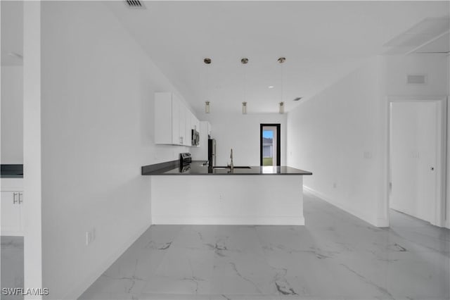 4646 Leonard Blvd S, Lehigh Acres, FL 33973 - kitchen with baseboards, dark countertops, white cabinets, light marble finish floors, and recessed lighting