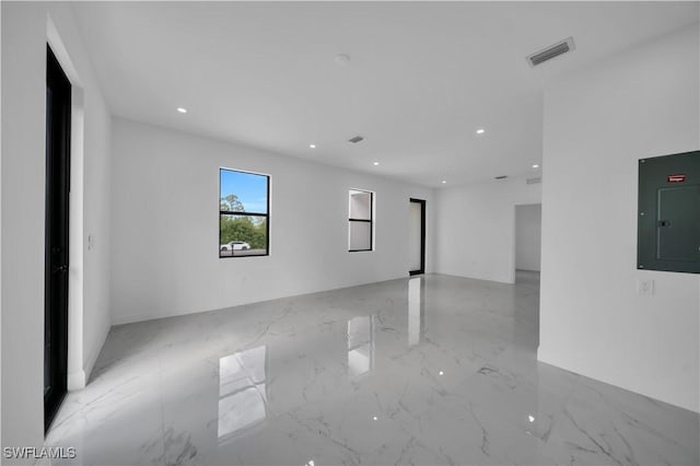 4646 Leonard Blvd S, Lehigh Acres, FL 33973 - empty room featuring electric panel, light marble finish flooring, and recessed lighting