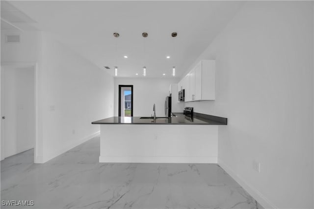 4646 Leonard Blvd S, Lehigh Acres, FL 33973 - kitchen featuring dark countertops, a sink, white cabinetry, light marble finish floors, and a peninsula