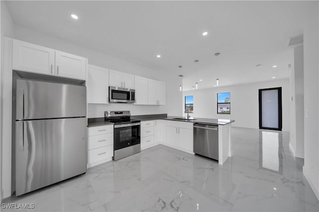 4646 Leonard Blvd S, Lehigh Acres, FL 33973 - kitchen featuring appliances with stainless steel finishes, a peninsula, light marble finish flooring, white cabinetry, and recessed lighting