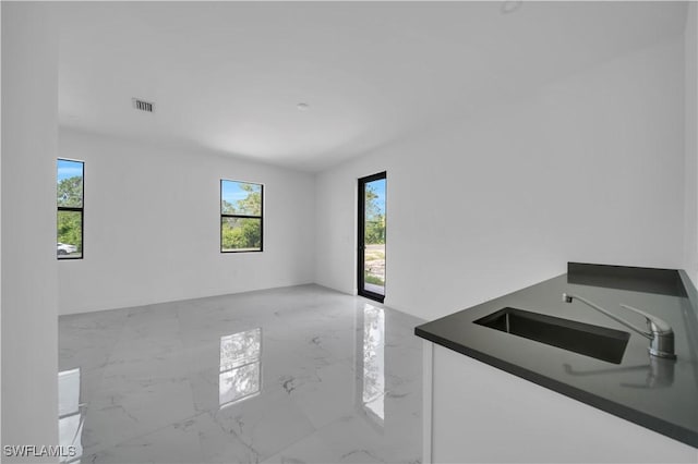 4646 Leonard Blvd S, Lehigh Acres, FL 33973 - spare room with healthy amount of natural light, marble tiled floors, and a sink