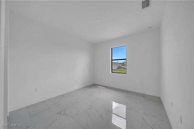 4646 Leonard Blvd S, Lehigh Acres, FL 33973 - spare room featuring light marble finish floors and baseboards