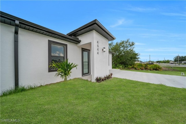 4646 Leonard Blvd S, Lehigh Acres, FL 33973 - view of home's exterior featuring a yard and stucco siding