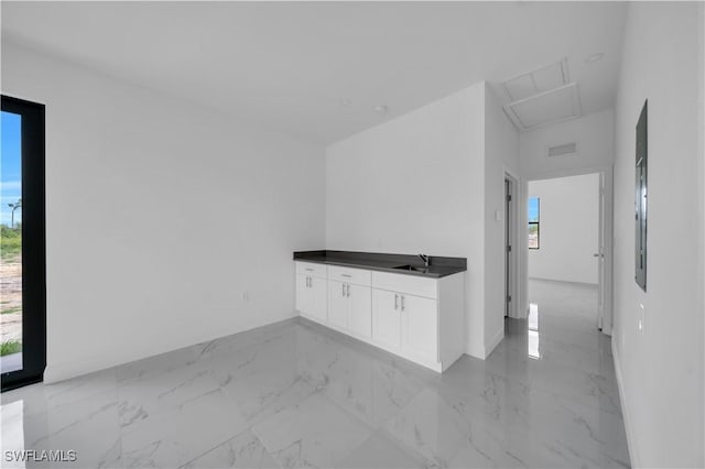 4646 Leonard Blvd S, Lehigh Acres, FL 33973 - spare room with a sink, light marble finish floors, healthy amount of natural light, and baseboards