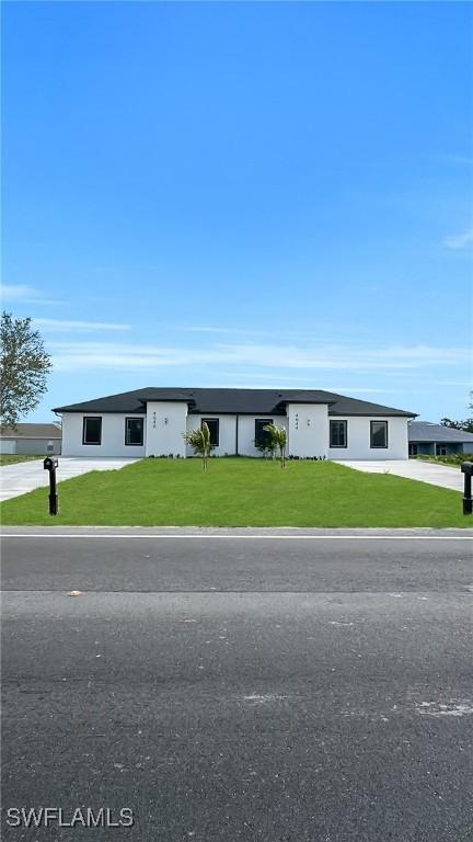 4646 Leonard Blvd S, Lehigh Acres, FL 33973 - view of front of house with a front yard