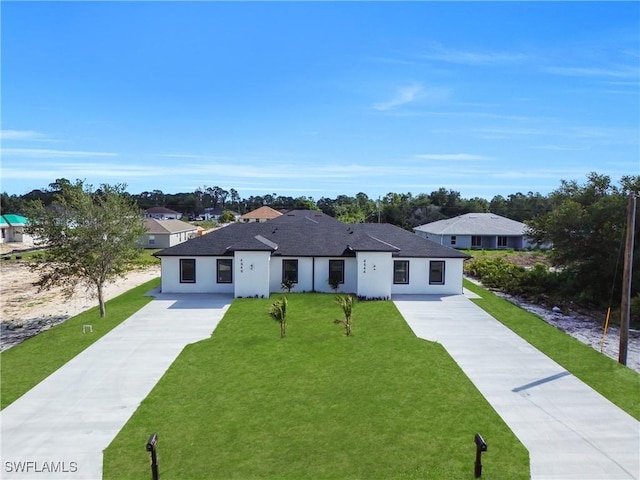 4646 Leonard Blvd S, Lehigh Acres, FL 33973 - view of front facade featuring concrete driveway, a front yard, stucco siding, and a shingled roof