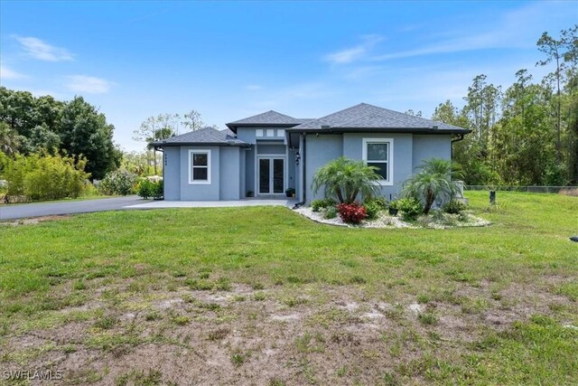 2948 2nd Ave NE, Naples, FL 34120 - prairie-style home with french doors and stucco siding