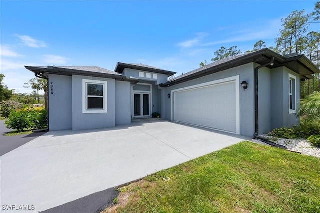 2948 2nd Ave NE, Naples, FL 34120 - prairie-style house featuring stucco siding, a garage, and concrete driveway