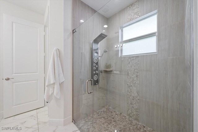 2948 2nd Ave NE, Naples, FL 34120 - full bathroom featuring tiled shower, marble finish floors, and baseboards