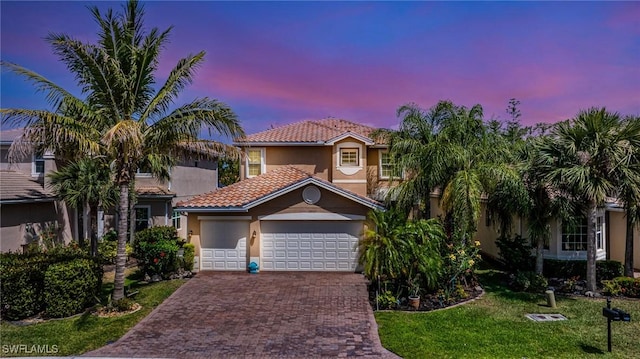 11221 Yellow Poplar Dr, Fort Myers, FL 33913 - mediterranean / spanish house featuring a tiled roof, stucco siding, decorative driveway, a front yard, and a garage