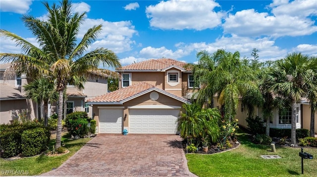 11221 Yellow Poplar Dr, Fort Myers, FL 33913 - mediterranean / spanish-style home featuring an attached garage, a tile roof, decorative driveway, and stucco siding