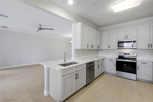 18911 Bay Woods Lake Dr Unit 102, Fort Myers, FL 33908 - kitchen featuring appliances with stainless steel finishes, a sink, light wood finished floors, light countertops, and ornamental molding